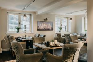 a restaurant with tables and chairs and a fireplace at Seaside 43 in Sankt Peter-Ording