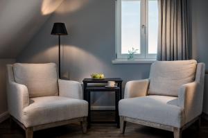 two chairs and a table in a room with a window at Seaside 43 in Sankt Peter-Ording