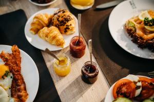 a table topped with plates of food with breakfast foods at Seaside 43 in Sankt Peter-Ording
