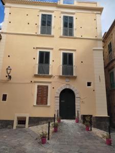 a large building with a black door and balcony at BellaVita accomodation in Tropea