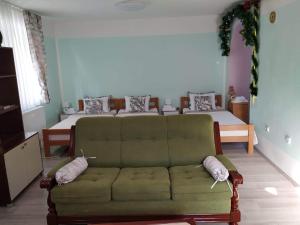 a living room with a couch and a bed at Apartman Nikola in Rakovac