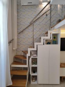 a staircase with a white cabinet in a house at Little House in Siracusa