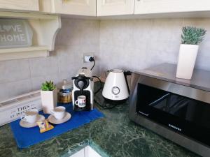 a kitchen counter with a coffee maker and a microwave at Casa Grace Pula in Pula