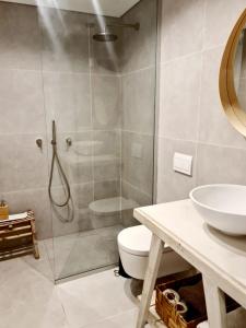 a bathroom with a shower and a toilet and a sink at Royal Park- Magical garden apartment in Eilat