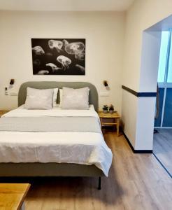 a bedroom with a bed and a painting on the wall at Royal Park- Magical garden apartment in Eilat