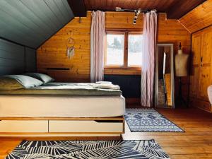 a bedroom with a bed in a wooden cabin at Moon House in Przesieka