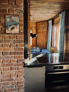 a kitchen with a brick wall and a counter top at Moon House in Przesieka