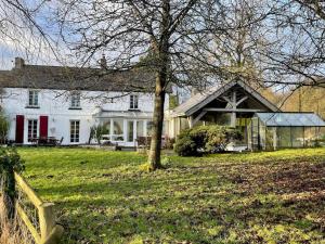 a white house with a tree in the yard at Entire country farmhouse in Cardiff