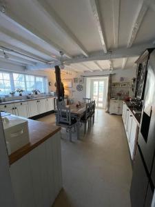 a large kitchen with a table and chairs in it at Entire country farmhouse in Cardiff