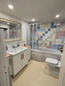 a bathroom with a sink and a toilet and a tub at Entire country farmhouse in Cardiff