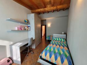 a bedroom with a bed and a desk in a room at Mountain and Iseo Lake Mountain Lake Iseo Hospitality in Bossico