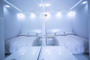 a room with two beds and a mirror at beautiful and comfortable apartment in the city center in an architectural building in Baku