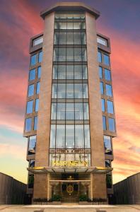 a tall building with a sunset in the background at Marine Inn Hotel in Cochin