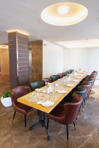 a long dining room with a long table and chairs at Marine Inn Hotel in Cochin