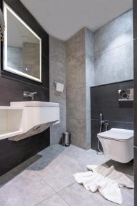 a bathroom with a sink and a toilet at Marine Inn Hotel in Cochin