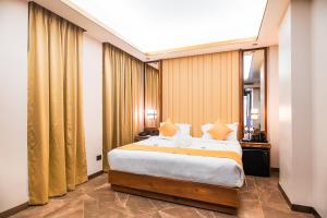 a bedroom with a large bed in a room at Marine Inn Hotel in Cochin