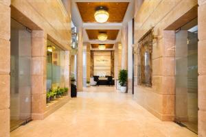 an empty hallway in a building with plants at Marine Inn Hotel in Cochin