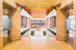 an internal view of a building with a hallway with plants at Marine Inn Hotel in Cochin