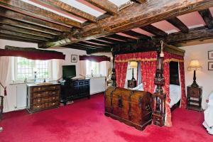 a bedroom with a large bed with a guitar at Hagg Hill Hall in Wingerworth