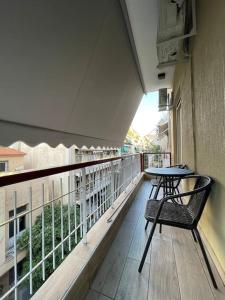 a balcony with a table and a bench on a balcony at ATH-Brand new 2bedroom apartment in Athens