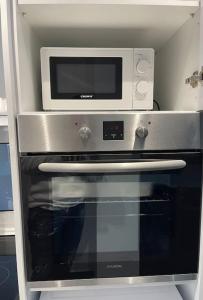 a microwave sitting on top of an oven at ATH-Brand new 2bedroom apartment in Athens
