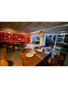 a dining room with a wooden table and chairs at Tigers Villa, Tala Bandhavgarh in Tāla