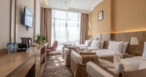 a hotel room with a row of beds at Emaar Legend in Mecca