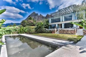 a house with a pool and mountains in the background at Purespace in Zhangjiajie