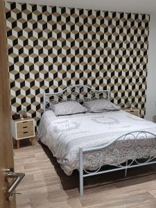 um quarto com uma cama e uma grande parede em chez Aline em Calais