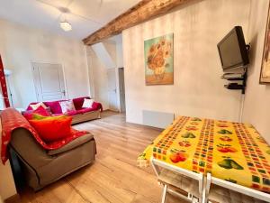 a living room with a couch and a table at Greener Pastures - Normandy Self Catering Gites in La Chapelle-Engerbold