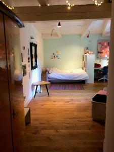 a bedroom with a bed and a table in a room at Monumental villa at the forest close to Haarlem and the beach in Heemstede