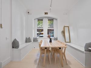 a dining room with a wooden table and chairs at VENUS Potts Point - FEMALE ONLY HOSTEL - Long stay negotiable in Sydney