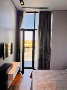 a bedroom with a bed and a large window at Baku, SEA BREEZE on the shores of the Caspian Sea in Bilgah
