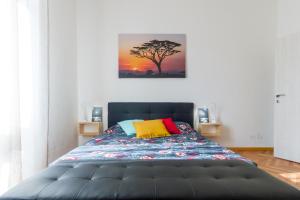 a bedroom with a bed with a painting on the wall at Casa Mazzini in Verona