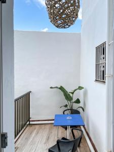 a blue table and a potted plant in a room at Beatriz Charming Hostal in Torremolinos +77 photos