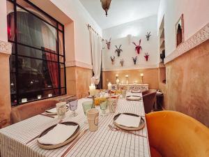 a dining room with a table with a white table cloth at DAR AURORA in Marrakesh