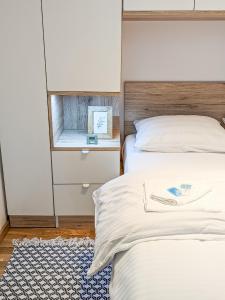 a bedroom with two beds and a mirror at Apartman Una in Kragujevac