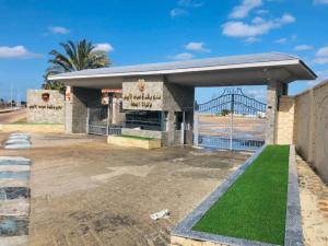 a building with a sign with a bridge in the background at El Obayed Apartments Armed Forces in Marsa Matruh