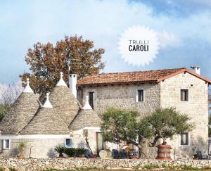 an old stone house with the words troll carol at Trulli Caroli in Locorotondo