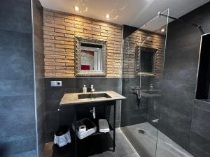 a bathroom with a sink and a shower at Casa Tapioles in Basella