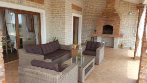 a living room with couches and a brick fireplace at Villa Melody Novalja in Novalja