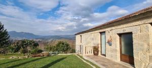 a stone house with a view of the mountains at Casa Lisboana in Pontevedra
