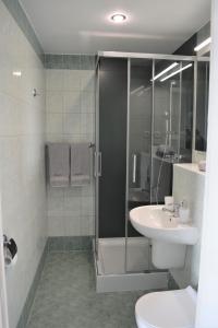 a bathroom with a shower and a toilet and a sink at Apartament Martini in Kołobrzeg