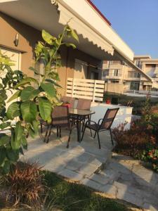 a patio with a table and chairs on a house at Estia House 1-2 in Nikiti