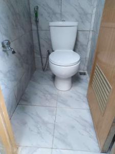 a bathroom with a white toilet and a shower at CBHaus in El Nido