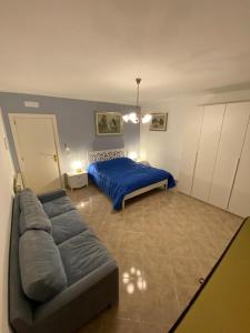 a bedroom with a bed and a couch in it at Residenze BepiLù in Bari