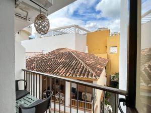 a view from the balcony of a house with a tile roof at Beatriz Charming Hostal in Torremolinos