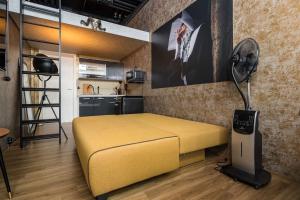 a bedroom with a yellow bed and a fan at Dresden Loft an der Elbe in Dresden