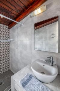 a bathroom with a sink and a mirror at Cavo Prima Kiotari in Gennadi