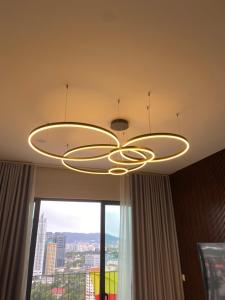 a chandelier hanging from a ceiling in a room with a window at Datum Jelatek Sky Residence KLCC SkyRing Linked to LRT and Mall in Kuala Lumpur